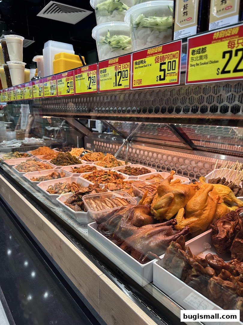 A display case filled with various prepared meats and side dishes at Scarlett Supermarket.