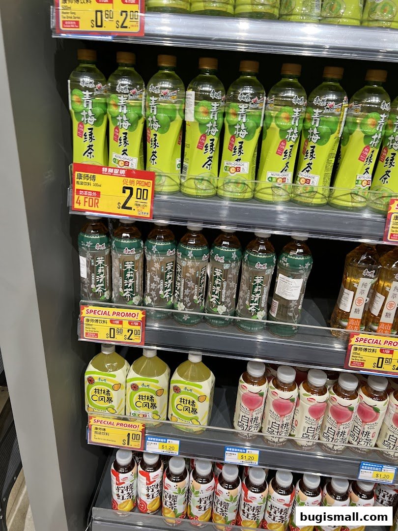 Shelves stocked with various bottled beverages, including green tea, citrus drinks, and white peach oolong tea.