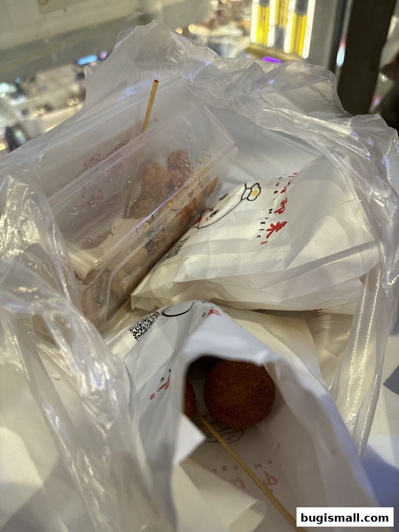 A plastic bag filled with various snacks on skewers from Scarlett Supermarket.