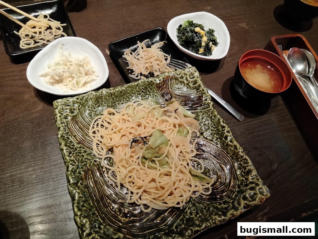 A close-up of a delicious scrambled egg rice dish with side dishes and miso soup.
