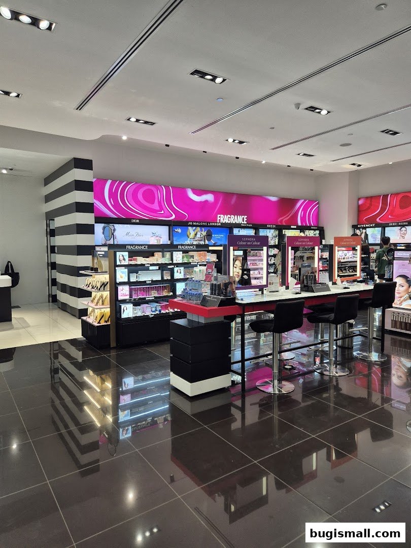 Interior view of a brightly lit Sephora store with makeup displays and seating.
