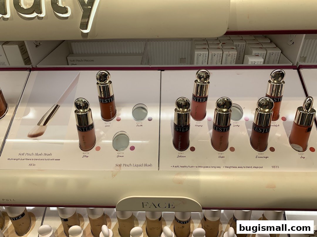 A display of Rare Beauty liquid and powder blushes with testers and product information.