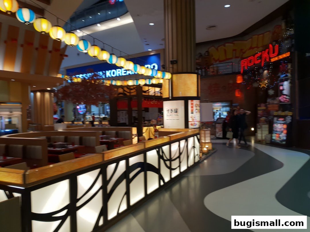Interior view of a restaurant with seating, decorative lanterns, and signage.