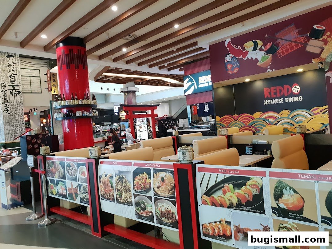 Interior of a Japanese restaurant with seating, menu displays, and vibrant wall art.