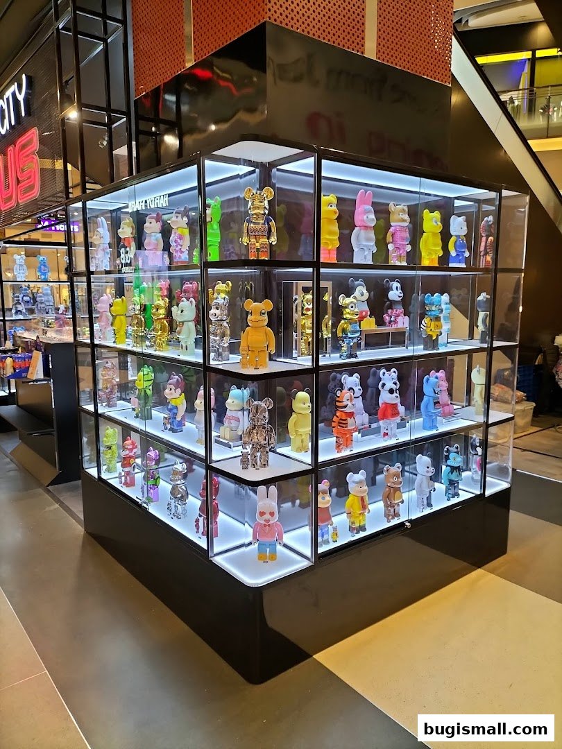 A display case filled with various collectible designer toys, illuminated by LED lights.