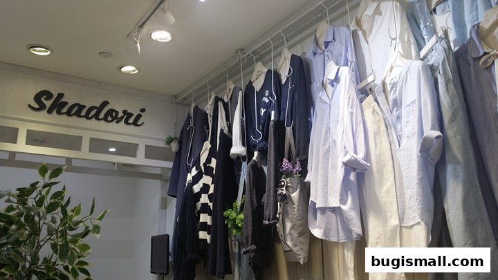 A display of stylish women's clothing, featuring shirts and dresses, at the Shadori shop.