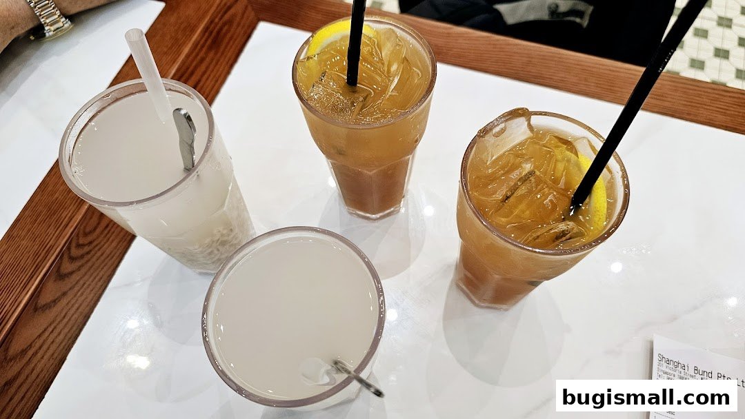 Four refreshing drinks, two iced teas and two milky beverages, served on a white table.