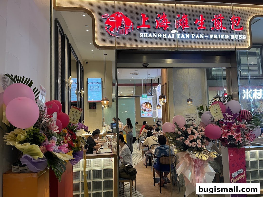 The exterior of Shanghai Tan Pan-Fried Buns shop with balloons and floral decorations.