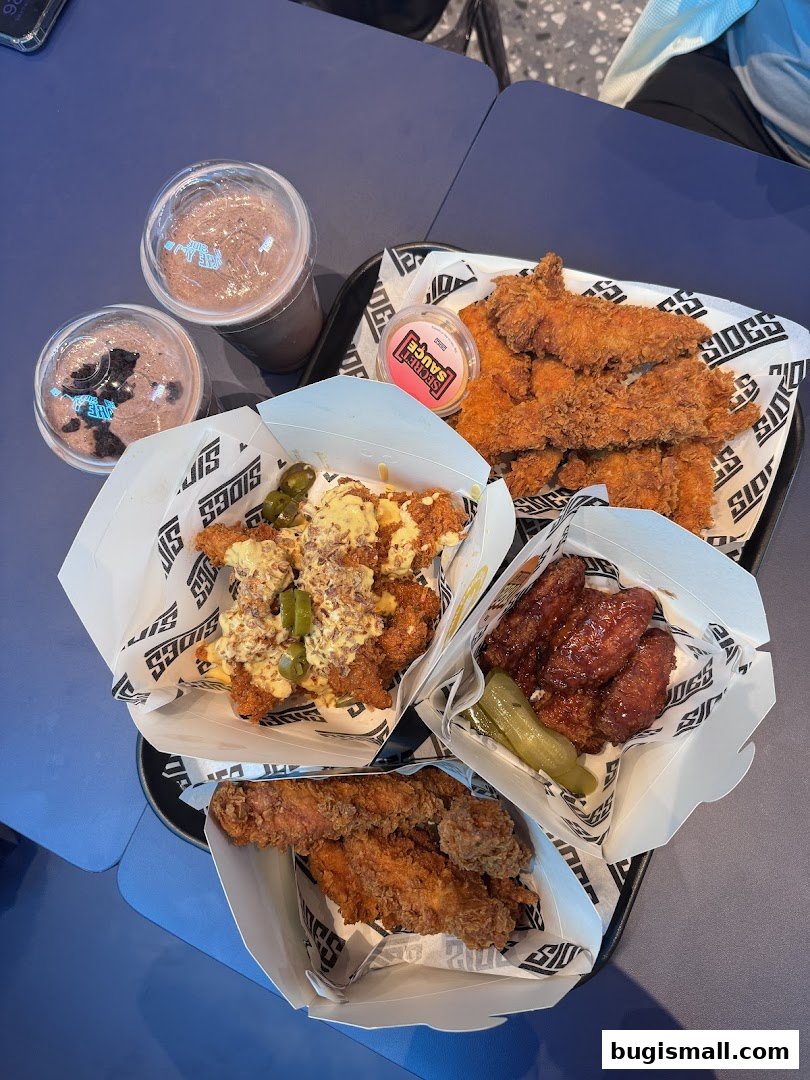 A variety of fried chicken dishes and drinks served in branded packaging.
