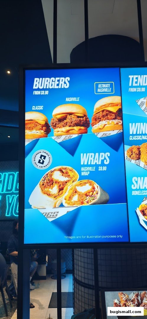 A digital menu board displaying burgers, wraps, and tenders from SIDES.