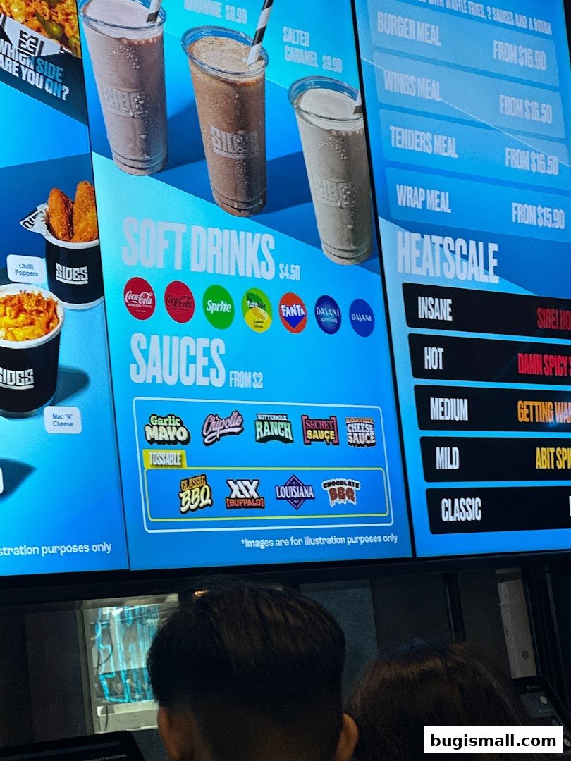A digital menu board displaying meals, drinks, sauces, and a heat scale for SIDES restaurant.