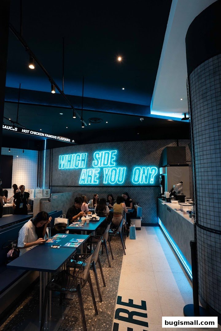 Interior of a modern restaurant with neon signage and customers dining.