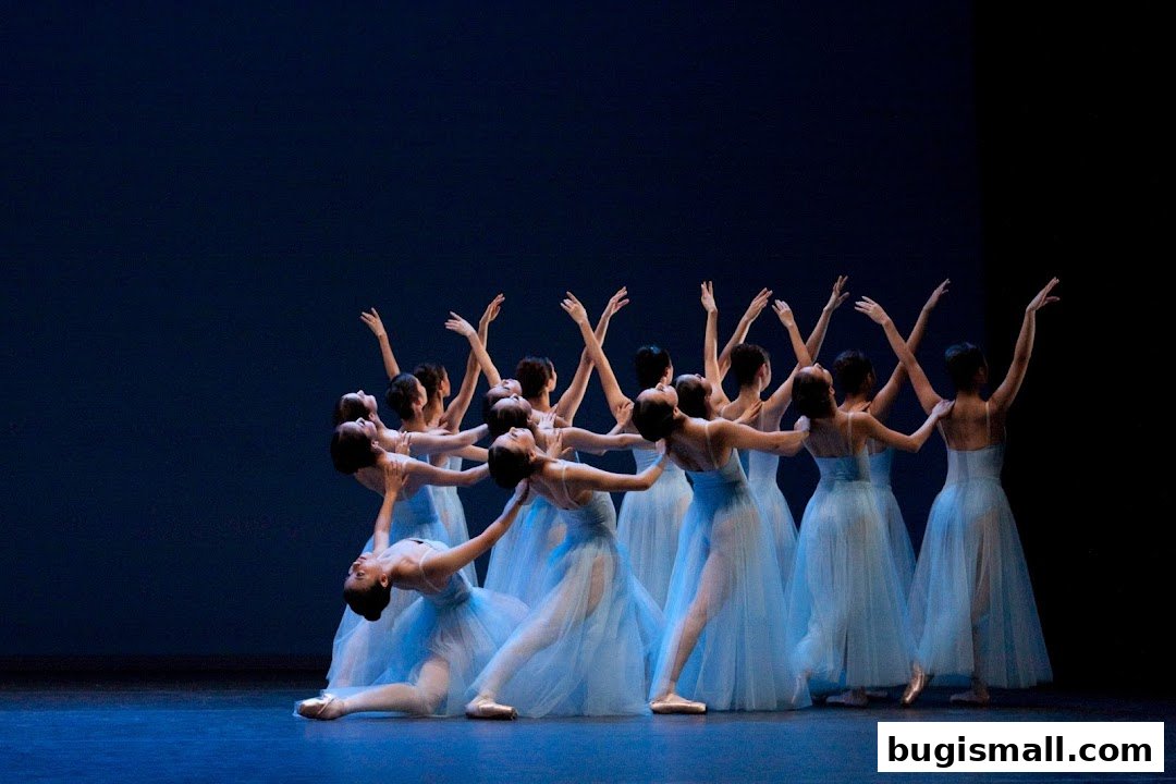 A group of ballet dancers in light blue tutus performing on a stage.