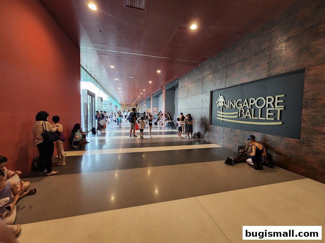 People gathered in a hallway outside the Singapore Ballet with its prominent signage.