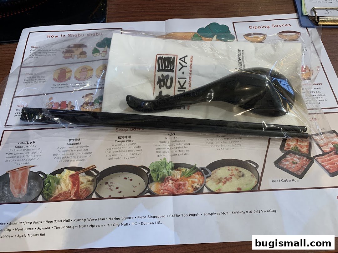A menu and cutlery set for Suki-Ya's all-you-can-eat shabu shabu.