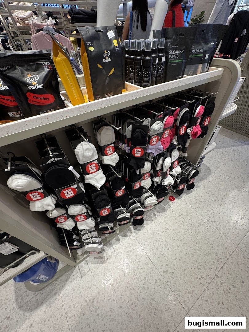 A display rack filled with various socks and shoe care products.