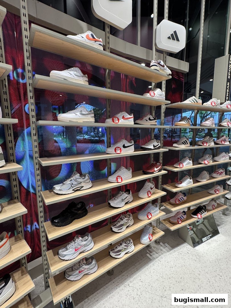 A wide selection of athletic shoes displayed on shelves in a retail store.