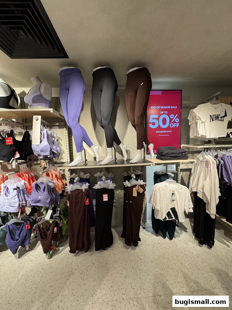 Mannequins display athletic wear, with a sale sign for up to 50% off.