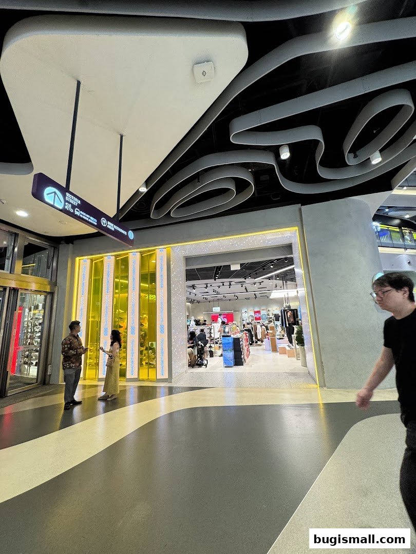 The entrance to Sun Sand Sports store with bright yellow and white displays.
