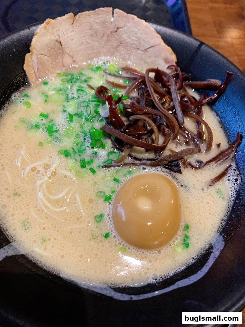 A close-up shot of a delicious bowl of ramen with chashu pork, egg, and wood ear mushrooms.