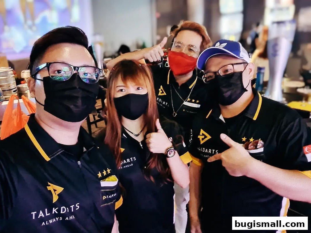 A group of four people wearing black shirts with the 'Talkdarts' logo, posing for a photo.