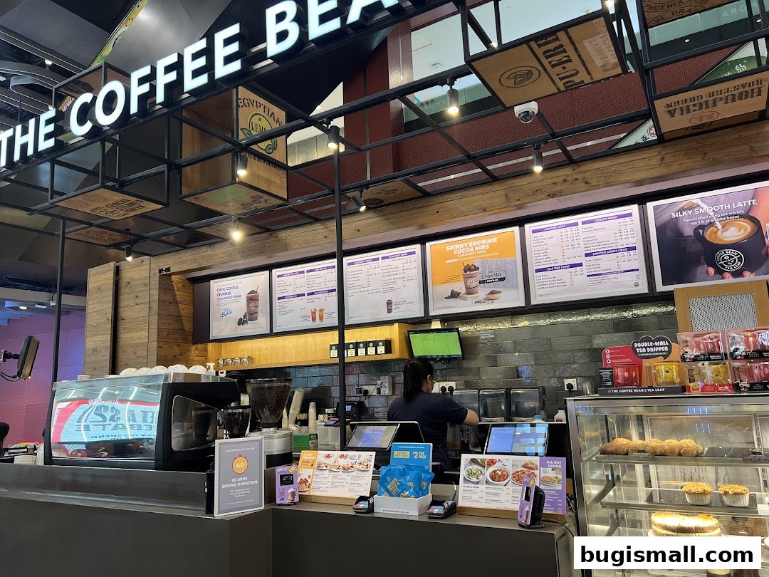Interior view of The Coffee Bean & Tea Leaf shop with menus, coffee machines, and pastries.