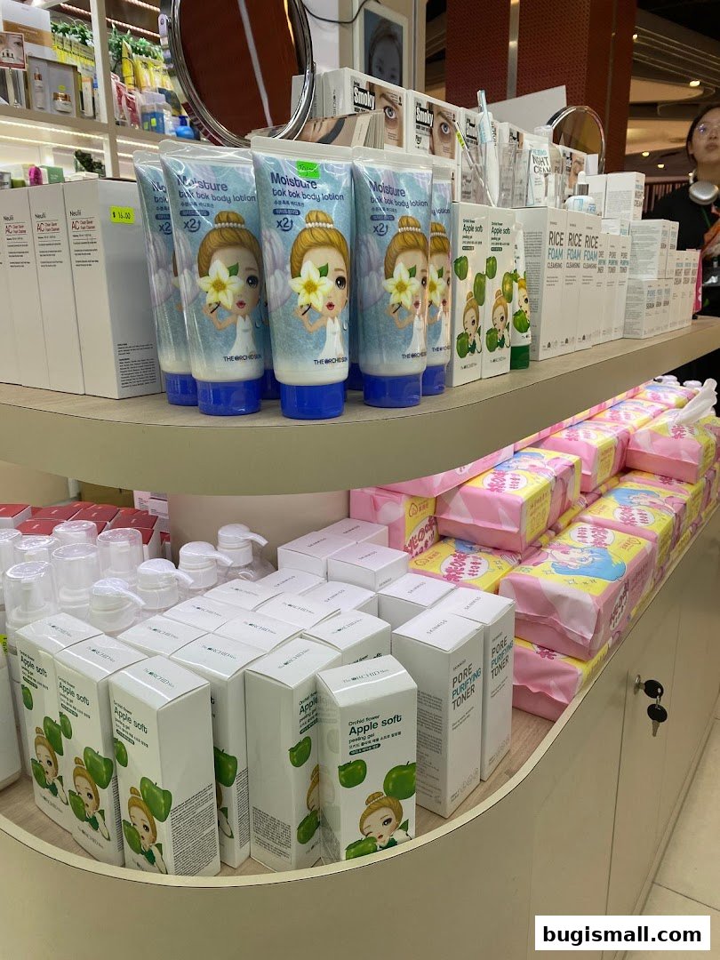 A display of various skincare products, including lotions, toners, and cleansing foams, on shelves.