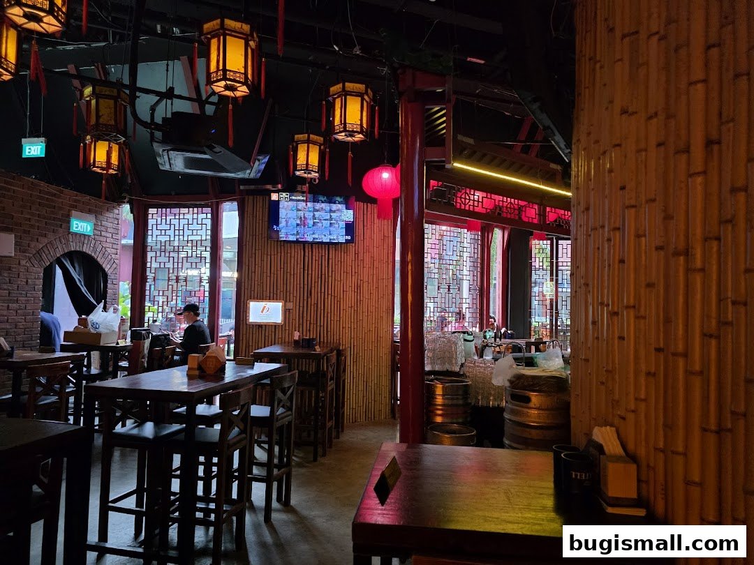 Interior of a bar with bamboo walls, traditional lanterns, and seating areas.
