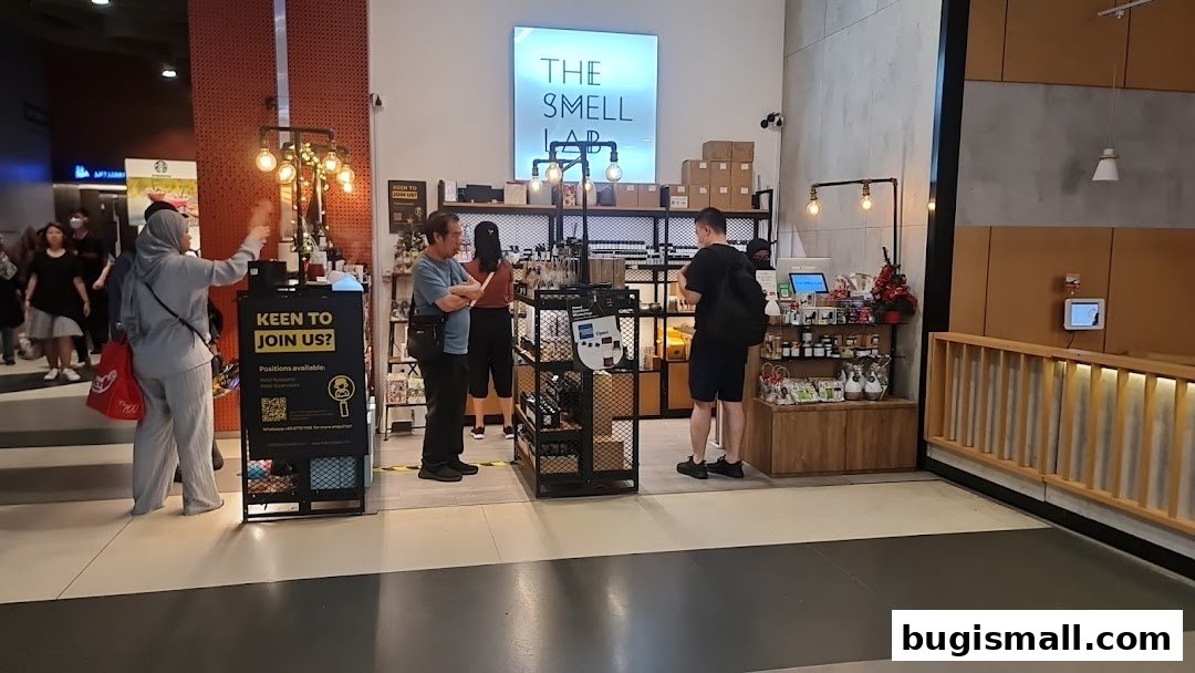 Customers browse products at The Smell Lab, a shop with a modern interior and illuminated signage.