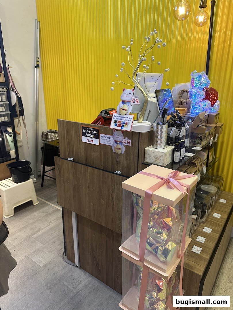 A shop counter with payment options, decorative items, and gift boxes.