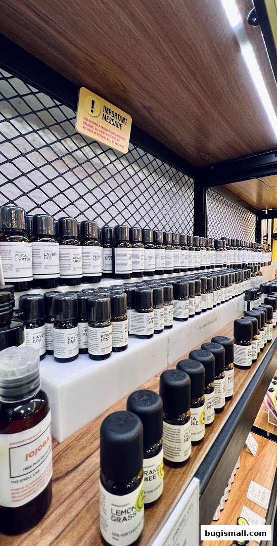 Rows of small essential oil bottles displayed on shelves in a shop.