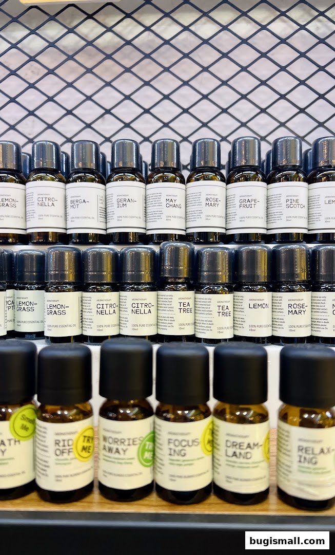 Rows of small amber glass bottles filled with essential oils, neatly arranged on shelves.