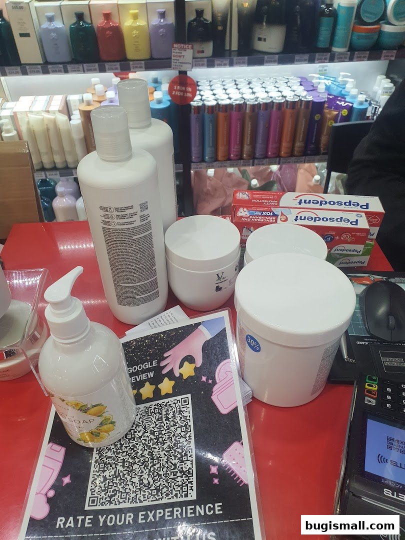 A counter display at Top Secret Studio with various beauty products and a payment terminal.
