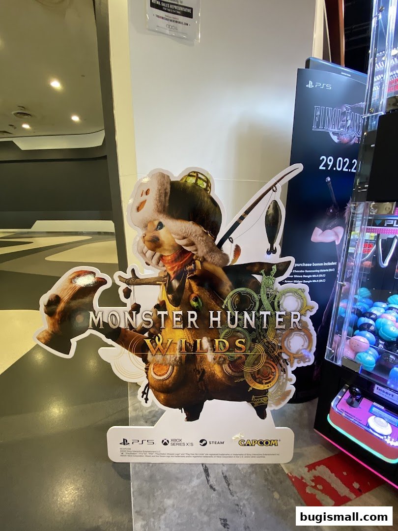 A cutout display for the game Monster Hunter Wilds, featuring a character and game logos.