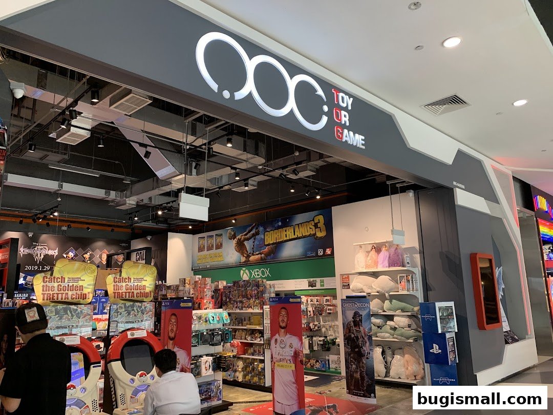 The entrance of a Toy Or Game store, showcasing video games, plush toys, and arcade machines.