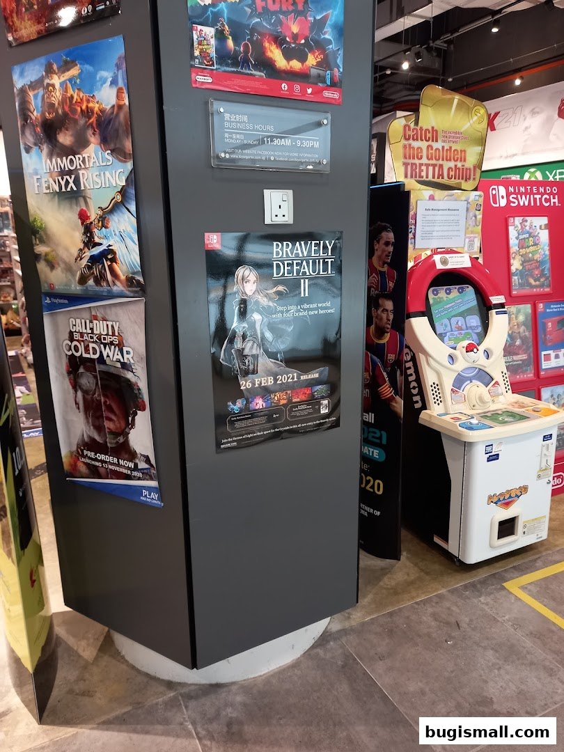 A display of video game posters and a gaming machine in a retail store.
