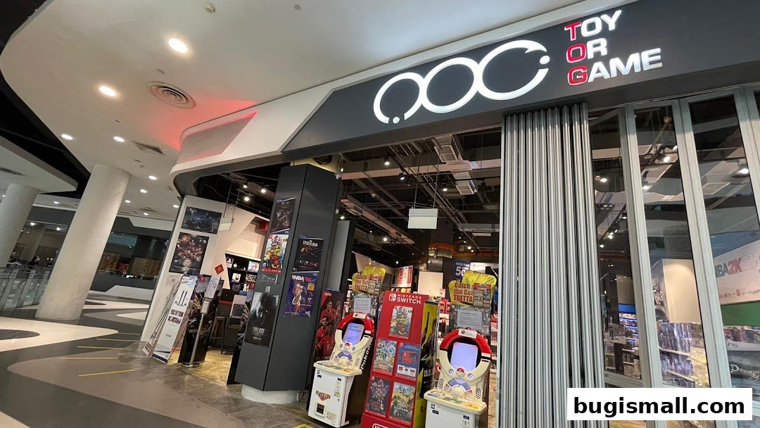 The entrance of a modern toy and game store with a prominent "Toy Or Game" sign and displays of games.