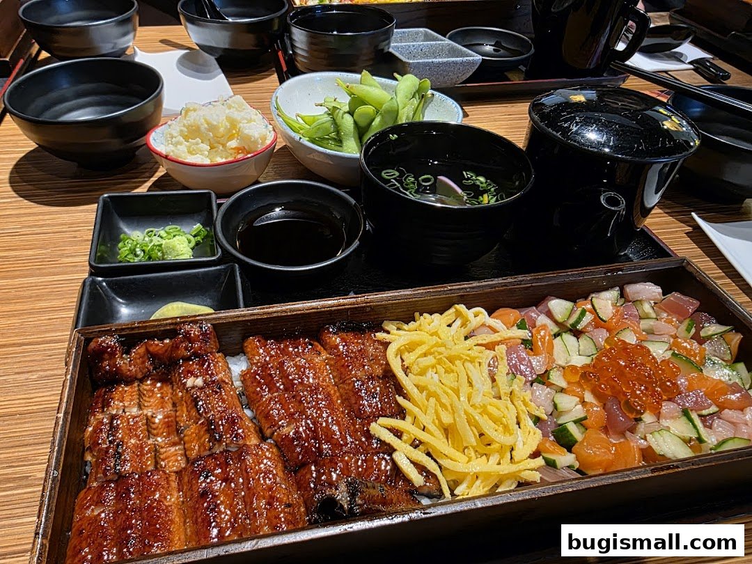 A close-up of a Japanese meal featuring grilled eel, chirashi, and various side dishes.
