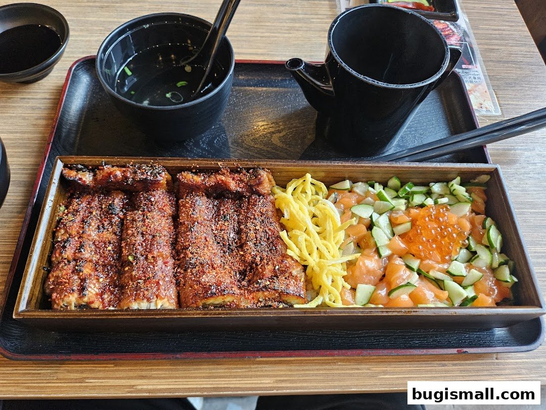 A delicious Japanese meal featuring grilled eel and salmon with cucumber and roe.