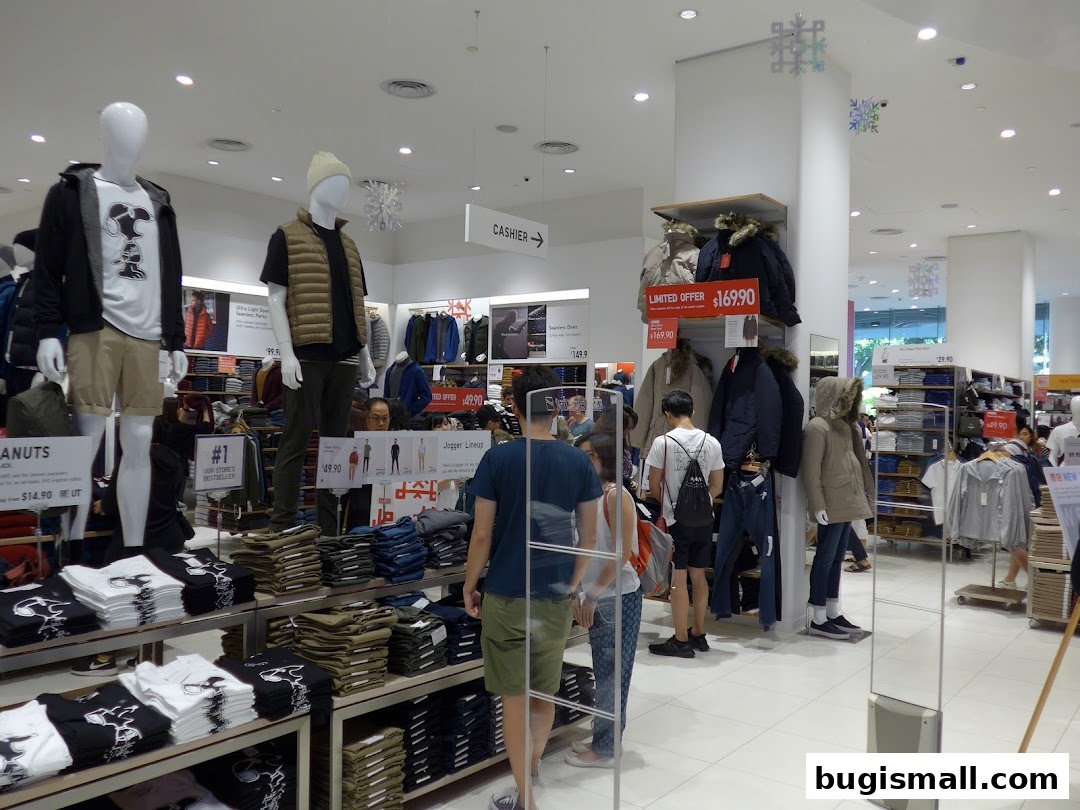 Interior view of a UNIQLO store showcasing clothing displays and mannequins.