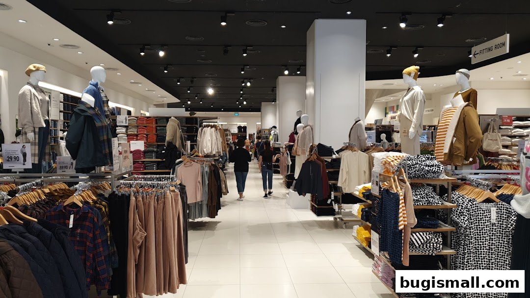 Interior view of a UNIQLO store showcasing clothing on mannequins and racks.