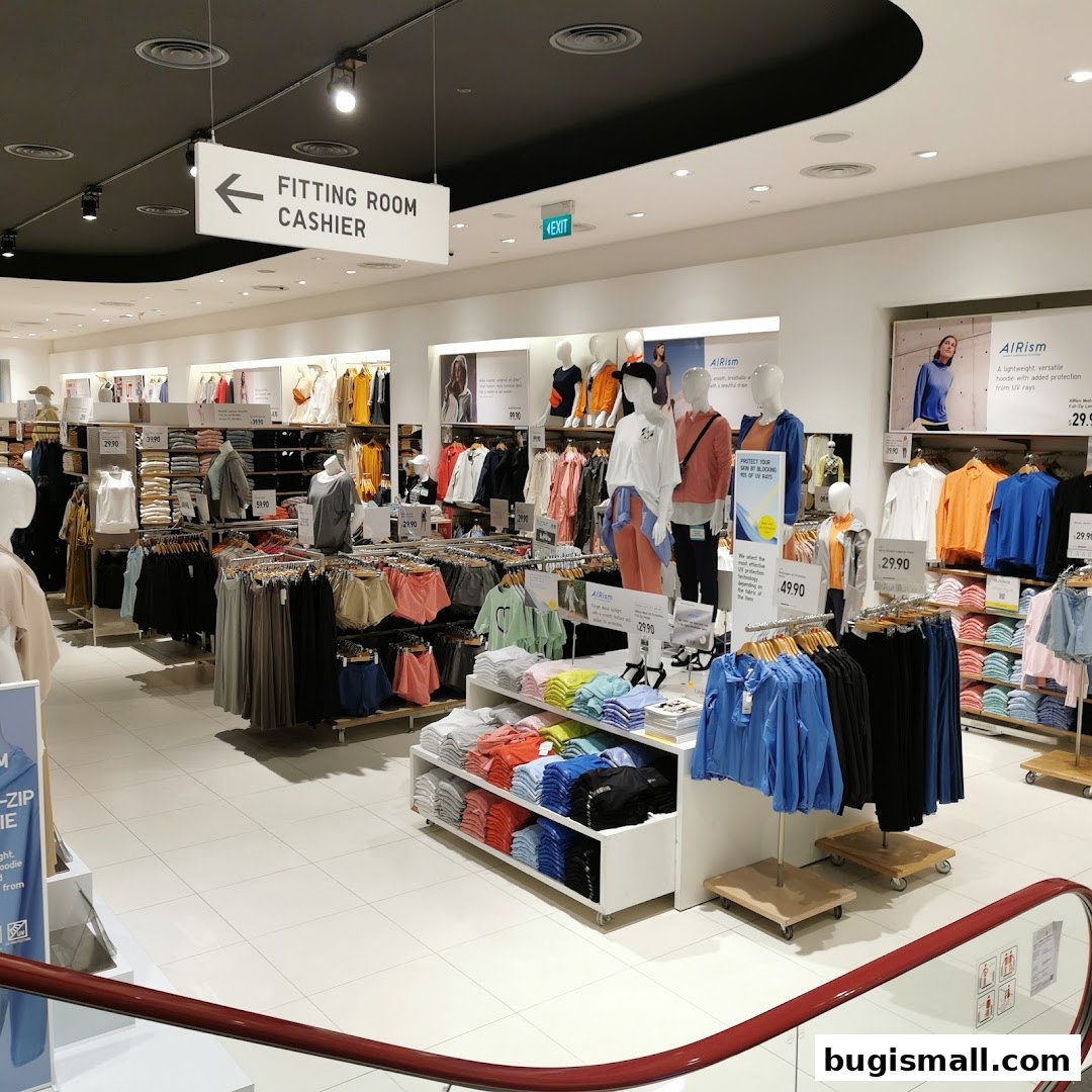 Interior view of a UNIQLO store showcasing clothing displays and mannequins.