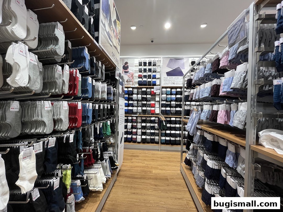 Interior view of a UNIQLO store showcasing a wide selection of socks and underwear on display shelves.