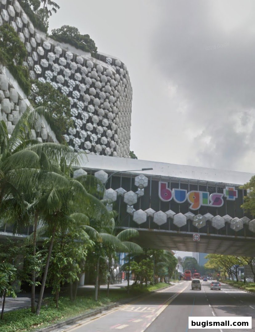 A street view of the Bugis+ shopping mall with its distinctive honeycomb facade and skybridge.