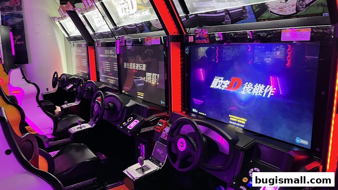Row of racing arcade game cabinets with steering wheels and gear shifts.