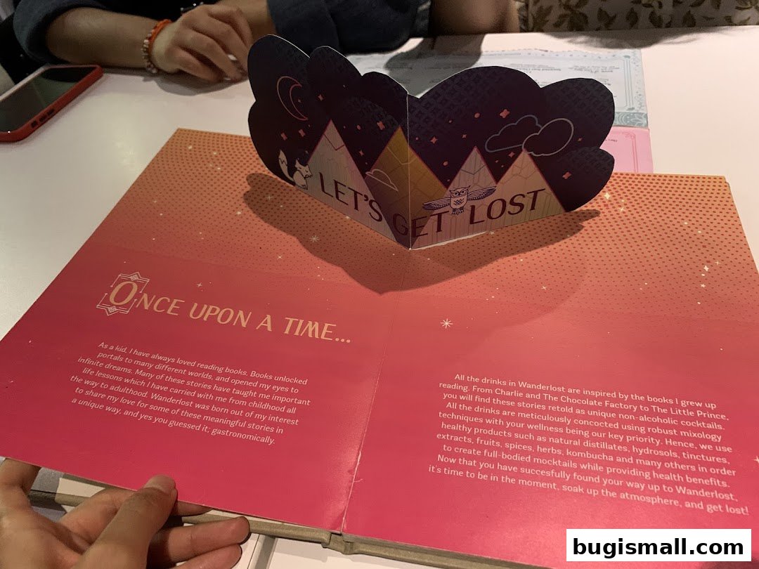 A book with a pop-up design and text about the inspiration behind the drinks.