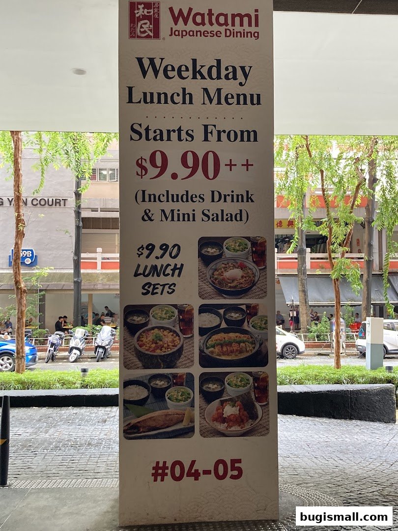 A sign advertising Watami Japanese Dining's Weekday Lunch Menu starting from $9.90.
