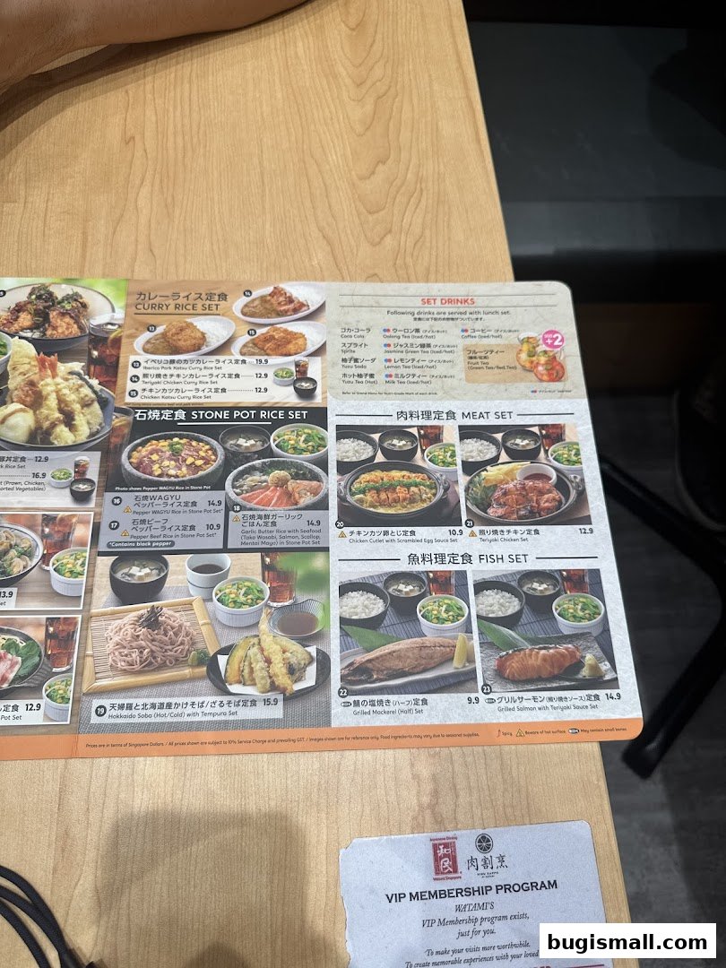 A menu from Watami Japanese Dining featuring various set meals like curry rice, stone pot rice, meat, and fish sets.