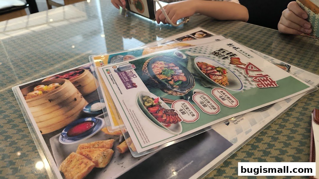 A close-up of several Hong Kong cafe menus featuring delicious food photography.