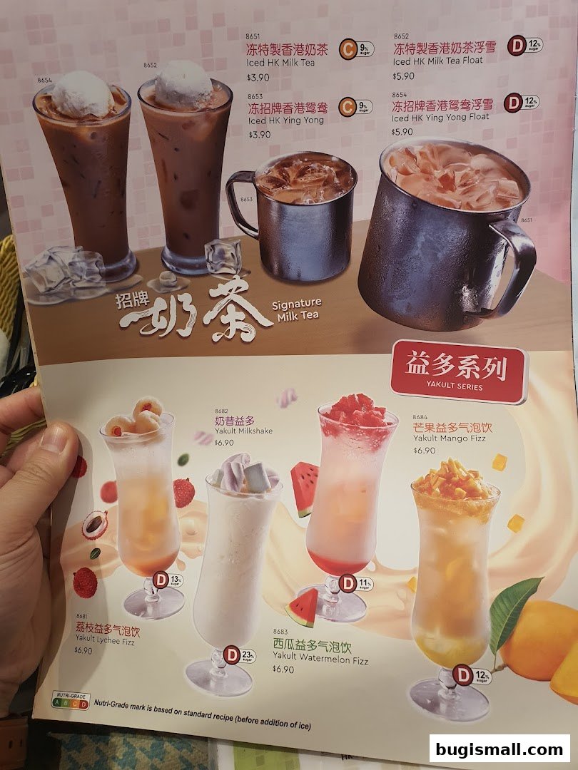 A menu featuring various Hong Kong-style milk teas and Yakult-based drinks with vibrant fruit garnishes.